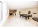Expansive finished basement features a ping pong table and plenty of space for entertaining or recreation at 10415 Charter Oaks, Carmel, IN 46032
