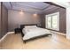 Stylish bedroom with tray ceilings, hardwood floors, and a large window at 10415 Charter Oaks, Carmel, IN 46032