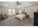 Cozy bedroom with carpet, tray ceiling, and a window offering a bright and airy space at 10415 Charter Oaks, Carmel, IN 46032