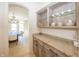 Convenient butler's pantry with granite countertops, custom cabinetry, and glass display shelves at 10415 Charter Oaks, Carmel, IN 46032