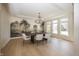 Elegant dining room boasts a decorative chandelier, designer wallpaper, and light-filled windows at 10415 Charter Oaks, Carmel, IN 46032