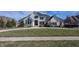 Beautiful two-story home with a large front lawn, circular driveway, and meticulous landscaping at 10415 Charter Oaks, Carmel, IN 46032