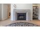 Modern fireplace with a stone mantel and hearth creates a cozy and inviting atmosphere at 10415 Charter Oaks, Carmel, IN 46032
