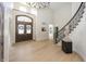 Spacious foyer featuring hardwood floors, double doors, grand staircase, and an open floor plan at 10415 Charter Oaks, Carmel, IN 46032