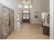 Bright foyer featuring hardwood floors, double doors, statement sculpture, and access to other rooms at 10415 Charter Oaks, Carmel, IN 46032