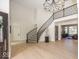 Stately foyer featuring a curved staircase, chandelier, hardwood floors, and an open floor plan at 10415 Charter Oaks, Carmel, IN 46032
