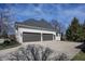 A three car garage with painted white brick, a grey roof, and a concrete parking pad at 10415 Charter Oaks, Carmel, IN 46032