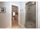 Hallway view that leads to a glass enclosed shower and walk-in closet featuring custom shelving at 10415 Charter Oaks, Carmel, IN 46032