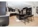 Stunning kitchen with dark cabinets, stainless steel appliances, hardwood floors, and a large center island at 10415 Charter Oaks, Carmel, IN 46032