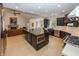 Spacious kitchen featuring dark cabinetry, stainless steel appliances, large center island, and hardwood flooring at 10415 Charter Oaks, Carmel, IN 46032