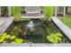 A tranquil pond features lily pads, goldfish, and a fountain for a relaxing ambiance at 10415 Charter Oaks, Carmel, IN 46032