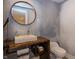Stylish powder room featuring custom stone sink, modern fixtures, and unique design elements at 10415 Charter Oaks, Carmel, IN 46032