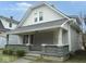 Quaint two-story home with a cozy front porch and classic design elements at 1056 N Mount St, Indianapolis, IN 46222