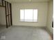 Bright room awaiting renovation, featuring a large window offering ample daylight at 1056 N Mount St, Indianapolis, IN 46222