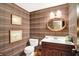 Traditional powder room with plaid wallpaper, framed art, and an oval mirror at 10614 Winterwood, Carmel, IN 46032