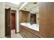 Bathroom with a double sink vanity, wood cabinets and a skylight above a large mirror at 10614 Winterwood, Carmel, IN 46032