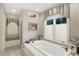 Sunlit bathroom features a built-in tub with a window and bench at 10614 Winterwood, Carmel, IN 46032