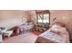 Carpeted bedroom with two twin beds, pink floral theme, and a large window at 10614 Winterwood, Carmel, IN 46032