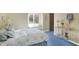 Charming bedroom with blue carpet and bedding, window seat and side table at 10614 Winterwood, Carmel, IN 46032