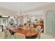 Elegant dining room featuring a large table, chandelier, and easy access to the adjacent living spaces at 10614 Winterwood, Carmel, IN 46032
