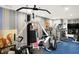 Bright workout room features a multi gym, treadmill and stripe accent wallpaper at 10614 Winterwood, Carmel, IN 46032