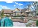 Beautiful stone and siding home with a screened in porch and lots of windows at 10614 Winterwood, Carmel, IN 46032
