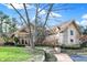 Charming stone and siding home with a beautiful landscaped front yard and walkway leading to the entrance at 10614 Winterwood, Carmel, IN 46032