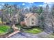 Traditional house with circular driveway, mature trees, landscaping and stone accents at 10614 Winterwood, Carmel, IN 46032