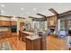 Open kitchen with hardwood floors, island with breakfast bar, and access to living and dining areas at 10614 Winterwood, Carmel, IN 46032