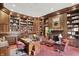Classic library with ample wood shelving, a desk, and comfortable seating, perfect for studying or relaxation at 10614 Winterwood, Carmel, IN 46032