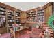 Spacious home library with built-in wood shelving, a cozy sitting area, and abundant natural light at 10614 Winterwood, Carmel, IN 46032