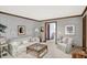 Comfortable living room with neutral color scheme and traditional-style furnishings at 10614 Winterwood, Carmel, IN 46032