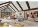 Open-concept living room with vaulted ceilings, wood beams, large windows, and seamless access to other living spaces at 10614 Winterwood, Carmel, IN 46032
