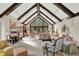 Bright living room features vaulted ceilings, wood beams, large windows, fireplace, and elegant decor at 10614 Winterwood, Carmel, IN 46032