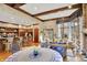 Spacious living room featuring hardwood floors, wooden beams, and bar area adjacent to the open concept kitchen at 10614 Winterwood, Carmel, IN 46032