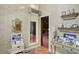 Charming home office nook with patterned wallpaper, built-in shelving and doorway to a library at 10614 Winterwood, Carmel, IN 46032