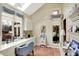 Cozy home office with built-in desk, cabinetry, patterned wallpaper, and sunlit windows, perfect for work or study at 10614 Winterwood, Carmel, IN 46032