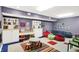 Spacious playroom with beanbag chairs, colorful rug, table, and ample storage for to enjoy at 10614 Winterwood, Carmel, IN 46032