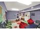 This room features a play area with whimsical wall paint, seating, and soft furnishings at 10614 Winterwood, Carmel, IN 46032