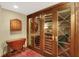 Close up of the wine cellar with glass doors to showcase your extensive collection at 10614 Winterwood, Carmel, IN 46032