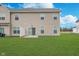 Home's back exterior featuring a sliding glass door for easy outdoor access and a well-maintained yard at 10628 Mangrove Dr, Indianapolis, IN 46239