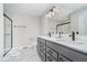 Modern bathroom with a double vanity, marble floors, walk-in shower, and sleek black fixtures at 10628 Mangrove Dr, Indianapolis, IN 46239