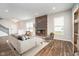 Bright living room featuring a modern fireplace, sleek hardwood floors, and contemporary decor for a stylish and comfortable space at 10628 Mangrove Dr, Indianapolis, IN 46239