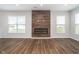 Spacious living room with electric fireplace, large windows providing natural light, and elegant hardwood flooring throughout at 10628 Mangrove Dr, Indianapolis, IN 46239