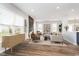 Open concept living room with large windows, modern furnishings, and seamless flow into the kitchen area, ideal for entertaining at 10628 Mangrove Dr, Indianapolis, IN 46239