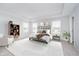 Bright main bedroom with a plush bed, neutral decor, ample natural light, and a cozy sitting area at 10628 Mangrove Dr, Indianapolis, IN 46239