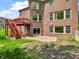 View of brick home from backyard shows a deck, patio, well-manicured lawn, and mature plantings at 10792 Harbor Bay Dr, Fishers, IN 46040
