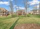 Spacious backyard featuring a well-maintained lawn, a red deck, and mature trees providing privacy at 10792 Harbor Bay Dr, Fishers, IN 46040