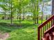 Spacious backyard featuring lush greenery and mature trees, accessed by a wooden staircase at 10792 Harbor Bay Dr, Fishers, IN 46040