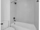 Bright bathroom features a white tiled tub and shower combo at 10792 Harbor Bay Dr, Fishers, IN 46040